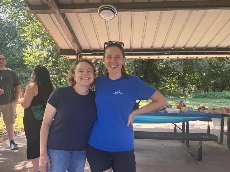 Two Trauma Specialists clinicians laughing together at a team gathering