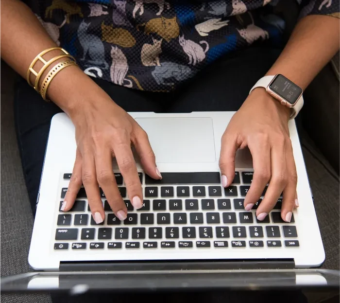 A clinician working at a laptop